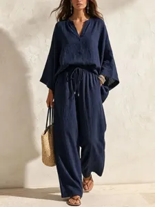 Detail view of a solid navy blue linen two piece set featuring a V neck loose top and pants.