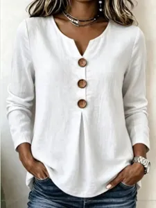Detailed view of women casual white V-neck long sleeve top with large wooden buttons.