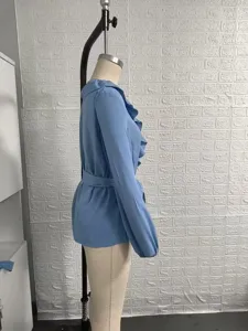 Side view detail of the elegant blue long sleeve blouse featuring a double ruffle V-neck.