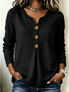 Close-up detail of women's long sleeve V-neck top featuring large decorative wooden buttons.
