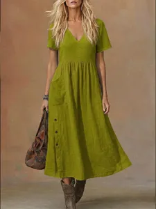 Green casual V-neck short sleeve pocket dress detail showing stylish loose fit and buttons.