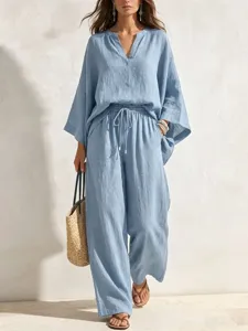 Casual light blue linen two-piece set featuring a relaxed V-neck top and wide-leg pants.