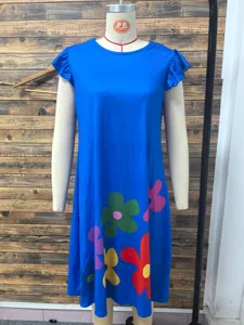 Detailed view of a blue short sleeve dress featuring vibrant colorful floral print at the hem.