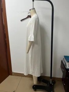 Side detail view of the white linen V-neck ruffle sleeve midi dress on a display form.