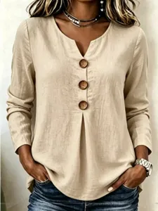 Detail shot of the khaki linen V-neck long sleeve blouse featuring large wooden buttons.