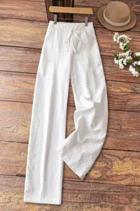 Detailed view of white linen casual wide-leg pants featuring comfortable drawstring.