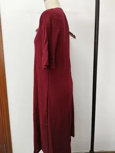 Side detail view of red midi dress, featuring comfortable fabric, elegant ruffles sleeves.