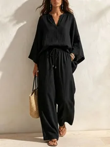 Casual black linen two piece set for women featuring a V-neck top and loose wide leg drawstring pants.
