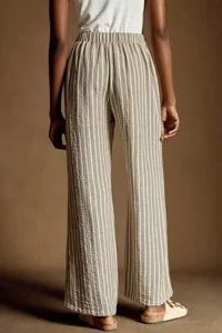 Detail view of casual linen wide-leg pants, high waist drawstring, back striped style.