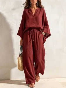 Detail shot of wine red linen two-piece set, V-neck loose top and wide-leg drawstring pants.