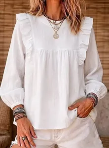 Close-up detail of women's white bohemian ruffle long sleeve blouse, textured fabric.