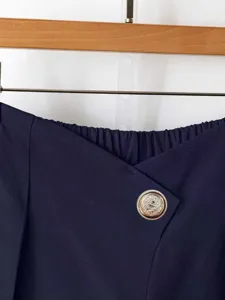 Navy blue high-waist wide-leg trousers detail with chic gold button and elastic waist.