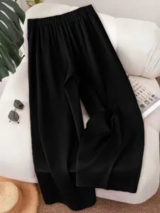 Detailed view of women's black wide leg trousers, casual high waist pants for daily wear.