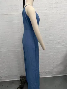 Detail view of blue textured halter jumpsuit, stylish waist design and draped wide leg.