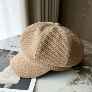 Close-up of British style newsboy cap featuring a retro houndstooth woven texture in khaki.
