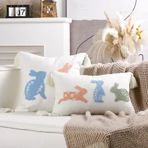 Easter bunny embroidered throw pillow cover detail scene with tassel design and cozy sofa setup
