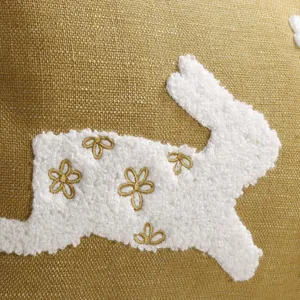 Close-up detail of Easter rabbit chenille embroidery pillow cover with gold floral accents.