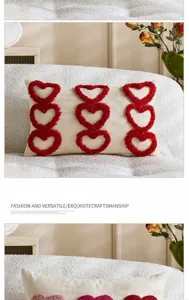 Close-up detail of cream throw pillow cover featuring red tufted heart embroidery design.