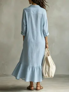 Back view of casual loose light blue shirt dress featuring a stylish fishtail hemline detail.