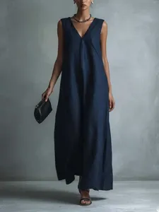 Detailed view of the elegant deep blue sleeveless v-neck long dress in studio setting.