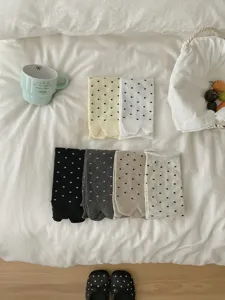 Detailed lifestyle flat lay shot of women cute polka dot split toe cotton mid tube socks