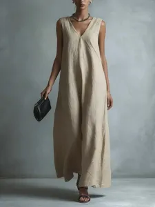 Close-up detail of beige V-neck sleeveless maxi dress, showcasing soft texture and drape.
