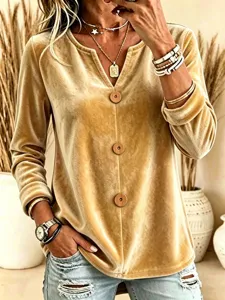 Close-up detail of the elegant velvet long-sleeve top featuring wooden buttons and V-neck.