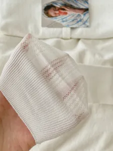 Breathable mesh fabric detail of white summer ankle socks, lightweight knit texture.