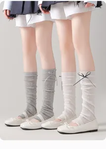 Detail view of breathable mesh knit leg warmers with cute bows for women fashion style.
