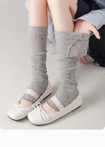 Detail shot of Japanese JK style grey knitted leg warmers with cute bow, breathable mesh.