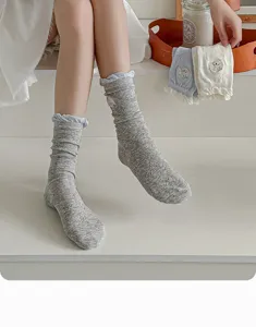 Detail view of women's summer cotton stack socks with cute embroidery and lace trim.