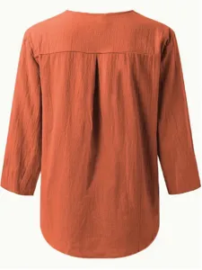 Detailed view of women casual long sleeve blouse in rust orange with back pleat design.
