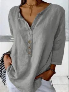Close-up view of the casual grey long-sleeve shirt featuring a stylish notch neck and wooden buttons.
