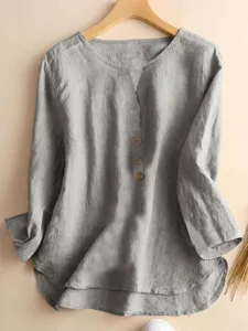 Close-up detail of the grey notched collar long sleeve casual shirt with button front design.