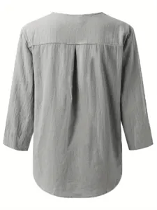 Back detail view of a grey casual long sleeve shirt with back pleat and curved hemline.