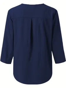 Solid navy blue long sleeve blouse for women with chic back pleat and curved hem design.