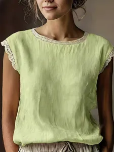 Close-up detail of vintage lace trim crewneck sleeveless linen top, casual solid color style.