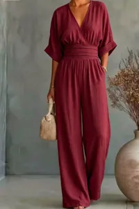 Detailed view of the elegant burgundy v-neck jumpsuit featuring cinched waist and wide legs.
