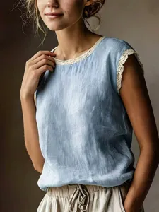 Close-up detail of the light blue sleeveless top with delicate lace trim neckline.
