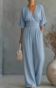 Detail view of the casual light blue V-neck women's jumpsuit with cuffed sleeves and waist.