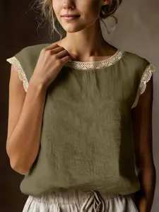 Detail of vintage sleeveless top with delicate lace trim on crewneck and arm openings.