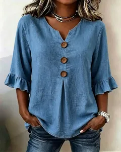 Blue denim V-neck top with wooden buttons and ruffle sleeves, casual summer apparel detail.