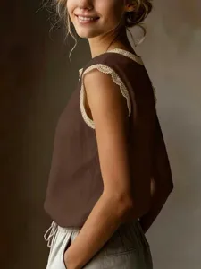Detail view of the retro brown sleeveless top featuring delicate beige lace trim around the neckline.