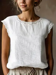 Close-up detail of women white sleeveless top featuring delicate lace trim around the round neckline.