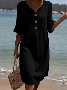 Women's black V-neck dress with wooden buttons and short sleeves, casual summer beach wear.