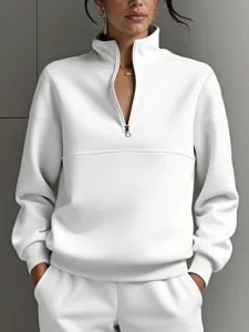 Detail view of a women's solid white half-zip long sleeve sweatshirt casual fashion top.