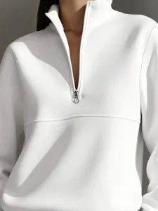 White half-zip sweatshirt collar detail close up, showing zipper pull and soft fabric.