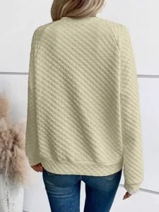 Back view detail of women's solid color quilted long sleeve casual sweatshirt pullover.