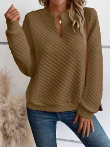 Detail view of women solid color quilted long sleeve deep V neck casual pullover sweatshirt.