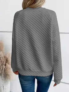 Close-up detail of women's grey quilted textured long sleeve casual sweatshirt back view.